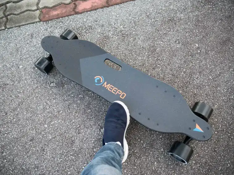 Close-up of the Meepo V3 electric skateboard highlighting its hub motors and maple deck